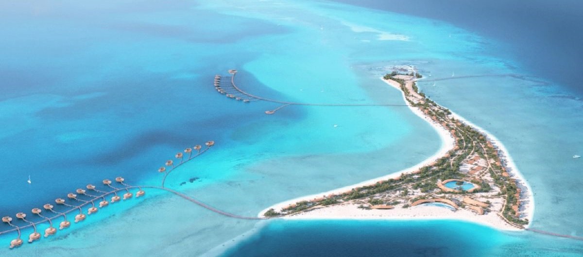 Vue aérienne d’une île au large d’Al Wajh en mer Rouge, avec villas sur pilotis et eaux turquoise, destination prisée pour la plongée
